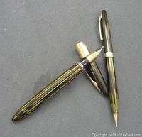 Sheaffer fountain pen and mechanical pencil with striped green and black finish and gold-tone accents.