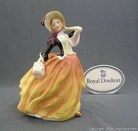 Frontal view of the Royal Doulton Autumn Breezes figurine with Royal Doulton sign visible.