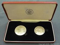 Both silver proof coins in original presentation box with cushioned interior and logo on lid.