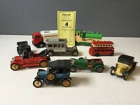Lot of eight English cast metal Corgi toy vehicles including a double decker bus and various vintage cars.