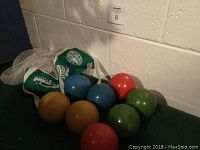 Photo showing all eight bocce balls grouped together with the mesh carry bag