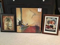Shows full lot of three framed prints: large square musical themed, abstract palm tree print, and framed piano players print.