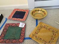 Top view of all 4 pottery items placed on carpet showing size and design variety