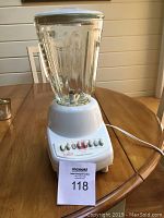 Full view of the Hamilton Beach blender showing the 1-liter glass container with lid mounted on the white base unit.