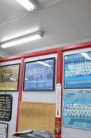 Wall-mounted framed sports posters featuring multiple teams including Team Canada and Toronto Blue Jays