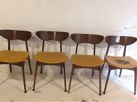 Front view of all four chairs in a row showing overall style