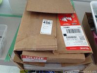 Two stacked cardboard boxes labeled Uline containing polypropylene bags.