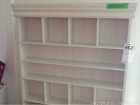 Full view of white wooden shelving unit showing multiple compartments and overall size.