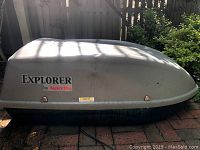 Front side view of the Explorer car roof cargo carrier, showing branding and condition.