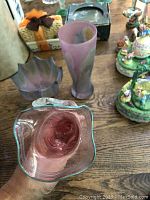 Set of two Venice-style art glass pieces on wooden surface including a tall vase and a decorative dish with ruffled edges.