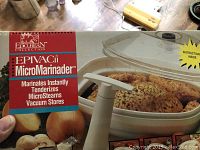 Close-up of Epiva MicroMarinader box showing brand, model, and image of vacuum container with chicken inside.