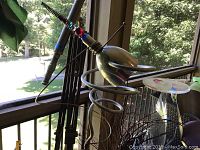Photo showing the clear pedestal with spiral bottom design and wax on top, located on a porch area with outdoor view.