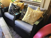 Two rocking patio chairs with cushions and pillows