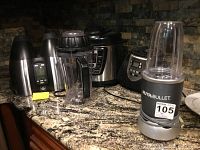 Overview of the NutriBullet blender, Power Cooker, and Health Master Elite juicer on granite kitchen counter.