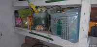 Shelf with various lawn and garden care products including fertilizer and seed bags