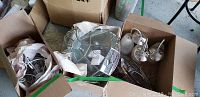 Box containing three frosted ceiling fixtures with attached wiring and plastic prisms, along with metal and glass parts.