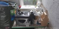Westinghouse deep fryer, kitchen canister set including bread box, sugar/flour container, salt and pepper shakers, and a wooden spice rack arranged on shelf.