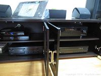 Shelf unit with Yamaha stereo receiver, CD player, cassette deck, and Samsung Blu-ray player
