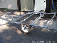 Front three-quarter view of galvanized steel rectangular frame with two wheels