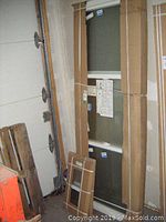 Sliding window in original cardboard packaging leaning against a wall