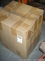 Closed cardboard box taped shut, labeled with Model 3833 and quantity of 5 sinks.