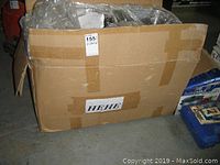 Box containing multiple new double stainless steel sinks.