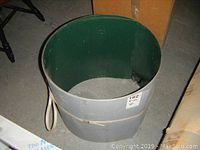 Rolled aluminum flashing sheets with dark green finish inside and metallic outside.