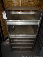 Front view of full shelving unit showing two open shelves above drawers