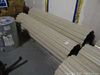 Two stacked roll-up door panels resting on floor next to water heater.