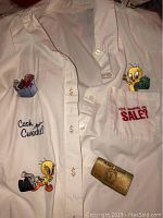 White women's long sleeve button-up shirt featuring Tweety Bird holding money design, with 'Did somebody say SALE?' text on pocket area.