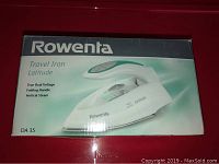 Front of the Rowenta DA 35 Latitude travel iron box showing product image and key features such as true dual voltage, folding handle, and vertical steam.