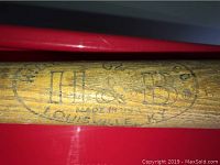 Close-up photo showing the H & B Co branding and Louisville KY stamp on the bat.