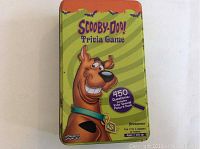 Front view of metal tin box with Scooby-Doo illustration and label showing 450 questions included
