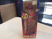 Spiderman gumball bank in original box showing dispenser with colorful gum balls inside.