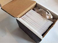 Box of hockey cards showing cards neatly stacked inside a cardboard box.