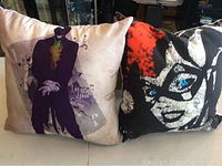 Two cushions featuring The Joker and Harley Quinn from Batman, front view.