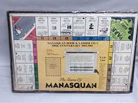 Top view of the game box showing the board and title 'The Game of Manasquan' for the Manasquan Hook & Ladder Co. 100th Anniversary from 1887-1987, sealed in shrink wrap.