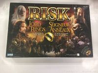 Front view of the Lord of the Rings themed Risk board game box showing the title and main characters from the films.
