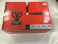 Front of the red box showing the Nintendo 64 racing wheel and compatibility with N64 racing games.