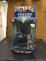 Front view of Justice League Crime Bust Batman figure in original box, with clear visible branding and figure details