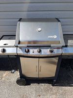 Full front view of closed Centro propane BBQ grill with temperature gauge and three control knobs.