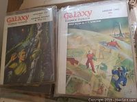Two Galaxy Science Fiction magazines from the 1950s with illustrated covers and visible dates 1953 and 1954, showing astronaut and futuristic space images.