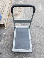 Front view of the push cart showing handle and base platform