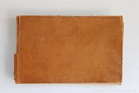 Exterior view of brown leather-bound album cover showing wear and edge fraying