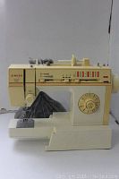 Full side view of the vintage Singer Merritt 4530 sewing machine showing stitch selector panel and stitch patterns above needle area.