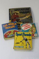 Four vintage 8mm film reels shown stacked, cases with colorful parade and event-themed illustrations