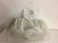 New white paper lantern set in original plastic packaging laid flat showing bundled lanterns with metal wire supports.