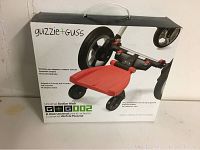Front of the original box showing the universal stroller board with red platform and black frame.