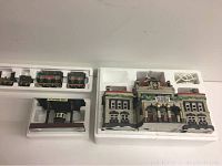 Overall view of the Flying Scot train pieces alongside the Victoria Station and platform, all set in Styrofoam packaging.