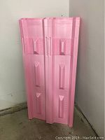 Stack of pink Owens Corning polystyrene roofing vent panels leaned against a wall, showing their length and molded vent areas.
